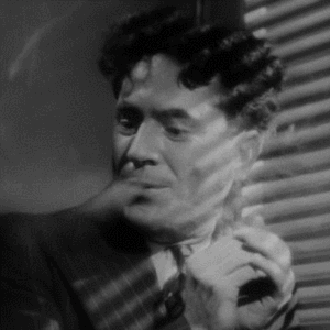 Animated gif showing black & white film clip of someone smoking in prohibition era